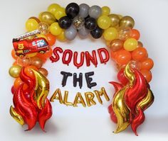 an assortment of balloons with the words sound the alarm written in red, yellow and orange