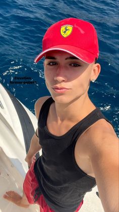 a woman wearing a red hat on top of a boat