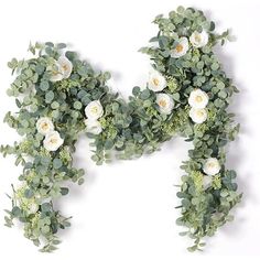 the letter n is made up of green leaves and white flowers