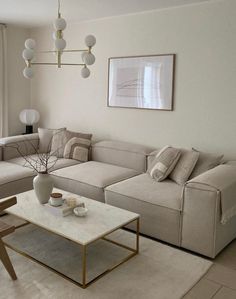 a living room filled with furniture and a large window covered in curtains, next to a coffee table