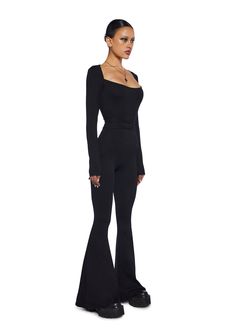 Darker Wavs Catsuit With Open Back And Tie Closures And Long Sleeves - Black – Dolls Kill Stretch Elastane Jumpsuits And Rompers For Night Out, Stretch Elastane Jumpsuit For Night Out, Chic Fitted Flare Jumpsuits And Rompers, Stretch Elastane Backless Jumpsuits And Rompers, Chic Fitted Elastane Jumpsuits And Rompers, Fitted Backless Jumpsuits And Rompers For Loungewear, Fitted Backless Jumpsuit For Loungewear, Chic Fitted Full-length Bodysuit, Chic Fitted Full Length Bodysuit