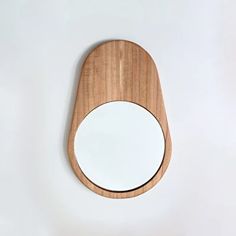 a wooden mirror hanging on the wall