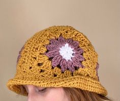 This handmade granny square crochet bucket hat is the perfect accessory to add a pop of color and style to any outfit. Made with care and attention to detail, each hat is crafted with a unique combination of colorful granny squares, creating a one-of-a-kind look. Whether you're running errands, lounging by the pool, or attending a music festival, this versatile hat is the perfect addition to your wardrobe. Care Instructions: Machine washable in cold water. Gentle cycle recommended. Lay flat to d Handmade Yellow Crochet Hat For Spring, Handmade Brown Crochet Hat For Spring, Handmade Yellow Crochet Bucket Hat, Handmade Yellow Brimmed Crochet Hat, Handmade Brown Bucket Hat For Spring, Retro Handmade Crochet Beanie, Retro Handmade Crochet Beanie Hat, Handmade Retro Crochet Hat, Handmade Retro Crochet Cap