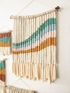 there are two wall hangings made out of macrame beads and tassels