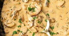 a skillet filled with mushrooms and sauce