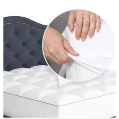 the mattress is being held up by someone's hand with their thumb on it