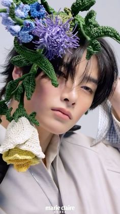 a young man with a flower crown on his head