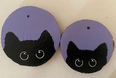 two black cats painted on purple wood slices