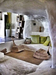 a living room filled with lots of white furniture