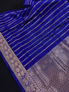 SILK MARK CERTIFIED !!Gorgeous Pure KatanSilk Blue Color with Copper and Slier Zari Work. Strips Sarees in Copper and Sliver Zari with Floral Buttas on the Pallu Soft, light weight and easy to drape Saree. The Strips are dense towards the pallu and get scattered the other end. Item : SareeColor : Blue ColorBase Fabric : Pure Katan Silk Blouse piece : Comes with Blouse pieceBlouse material : Pure Katan SilkFall & Edging (Yes/No) : YesComes with Silk Mark Certificate (Yes/No) : Yes Disclaimer -:- Luxury Katan Silk Lehenga With Zari Weaving, Luxury Katan Silk Saree With Cutdana Detailing, Blue Banarasi Silk Set For Puja, Blue Dupatta With Traditional Patterns For Celebration, Blue Zari Weaving Set For Puja, Blue Traditional Wear With Zari Weaving For Celebration, Blue Art Silk Traditional Wear For Celebration, Blue Silk Traditional Wear For Celebration, Blue Handloom Traditional Wear For Celebration