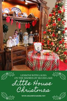 a christmas display with dolls and other items on the shelf, in front of a christmas tree