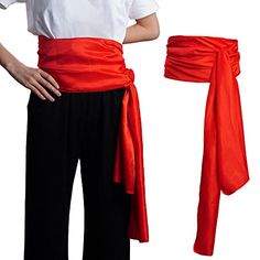 a woman wearing a red sash and black pants