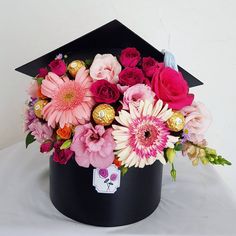 a graduation cap with flowers and chocolates in it