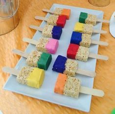 marshmallow pops are arranged on a white plate