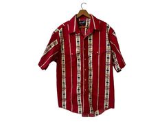 "1980s Vintage Wrangler Aztec Print Western Shirt Red White Multicolor Shortsleeve Pearl Snap Buttons Front Pockets Men's XL ☆ SIZE: The tag is missing. Measurements appear to fit a Men's  XL.  Please see measurements below. ☆ MEASUREMENTS (inches, item lying flat): ✄ Length: 31\" ✄ Width (armpit to armpit): 26\" ✄ Arms (armpit seam to cuff): Shortsleeve ☆ COLOR: Red, White, Multicolor ☆ MATERIAL: Unknown, likely a cotton  ☆ BRAND: Wrangler ☆ CONDITION: The item is vintage and previously loved. Red Top For Summer Rodeo, Red Summer Top For Rodeo, Retro Red Tops With Pockets, Vintage Red Tops For Rodeo, Mens Vintage Wrangler Pearl Snap, Western Button-up Tops With Pockets, Irish Knitwear, Vintage Button-up Shirt For Rodeo, Red Snap Button-up Shirt