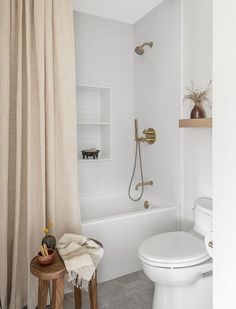 a bathroom with a toilet, tub and shower curtain