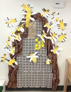 a bulletin board made to look like a beehive with bees on the door