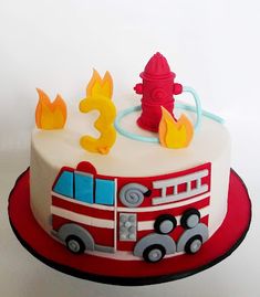 a birthday cake with a firetruck on top