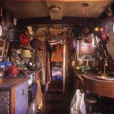 an old fashioned kitchen with lots of pots and pans