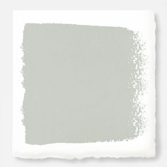 a white square with some gray paint on it's side and the color is light green