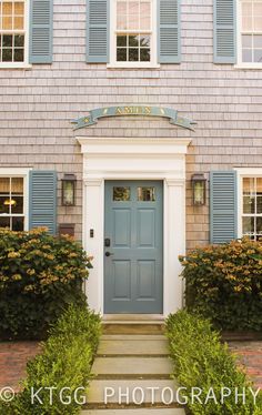 a blue front door and steps leading to a house