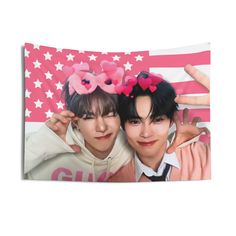 two people with flowers on their heads are posing in front of an american flag background