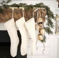 christmas stockings hanging from a mantel with bells