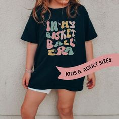 "This cute kids t-shirt is perfect for tweens, reading \"In My Basketball Era\" in on-trend fall colors and a retro wavy font. It would make the perfect birthday or Christmas gift for your favorite little basketball player! It can also be adapted for almost any sport or hobby, please contact me for custom requests : ) It's printed just for you on a buttery soft 100% cotton youth sized Bella Canvas tee that comes in lovely heather color options.  Because these are made to order, please allow a li Playful Relaxed Fit T-shirt With Letter Print, Eras Tshirt, Wavy Words, Lacrosse Sweatshirt, Kids Volleyball, Wavy Font, Balls Shirt, Volleyball Gifts, Kids Basketball