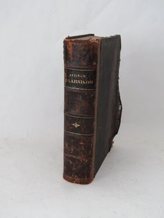 an old book sitting on top of a white table