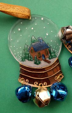 an ornament with a house and bells on it