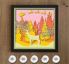 an image of a deer in the woods surrounded by three white knobs on a wooden surface