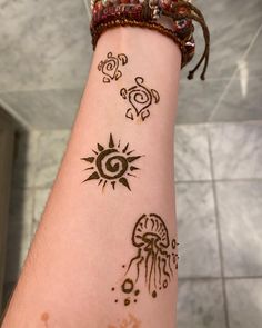 a person with henna tattoos on their arm