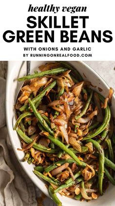 a white bowl filled with green beans and onions