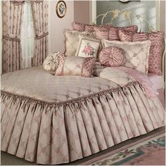 the bed is made up with pink and white bedspread, pillows, and curtains