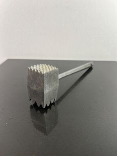 a metal object sitting on top of a black table