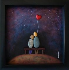 two rocks sitting on top of a wooden bench under a red heart shaped balloon in the sky