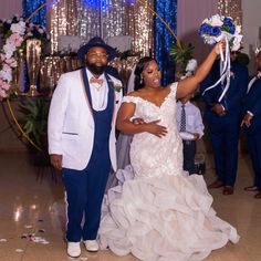 a bride and groom pose for a photo in front of their guests at a wedding