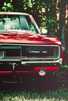 a painting of a red car parked in front of a tree on the side of a road