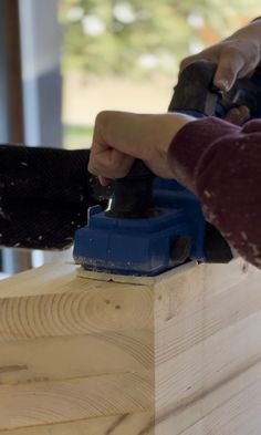 a person using a power tool on wood