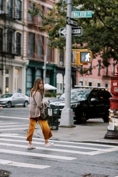 a woman crossing the street at an intersection