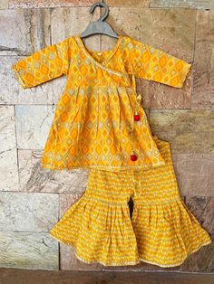 Beads shown on top/ Kurti are not attached for sizes under 3 years. Specifications: *Brand - Ethnic Pehnava *Type - Sharara *Fabric -Cotton *Sleeves - 3/4 th sleeves *Neck - Round *Closure - Pullover / Hooks *Lining - Butter Crepe (Very Soft) *Salwar Length - Full Palazzo / Elastic in waistband *Occasion - Ethnic Wear/Festive wear/Party Wear/Wedding Party *Fit - Regular Items included in Package *1 Kurti, 1 Palazzo Wash Care Instructions: HAND WASH /GENTLE WASH ONLY. Wash dark colors separately. Cotton Long Sleeve Palazzo Set With Gota Work, Cotton Palazzo Set With Gota Work And Long Sleeves, Long Sleeve Cotton Palazzo Set With Gota Work, Eid Long Sleeve Matching Sets, Long Sleeve Matching Palazzo Set For Eid, Long Sleeve Palazzo Set For Eid, Long Sleeve Matching Set For Eid, Long Sleeve Sets For Eid, Cotton Pant Set For Designer Wear At Festivals