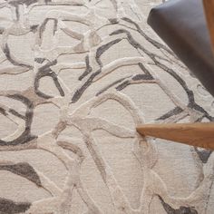 a close up of a chair and rug on the floor