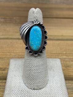 This beautiful vintage ring features a stunning oval-shaped turquoise stone set in a sterling silver band. The southwestern design adds a touch of unique style to this piece, making it a perfect addition to any collection. The ring has a ring size of 5.5, with a bandwidth of 3 mm. We can size most rings for an additional fee, please message me what size you need and I will get back to you with a price. The turquoise stone length is 20.5 mm and 11 mm wide. The color of the stone is vibrant blue, Southwestern Turquoise Ring With Oval Cabochon, Silver Oval Turquoise Ring With Concho Detail, Southwestern Oval Cabochon Turquoise Ring, Silver Oval Turquoise Ring With Concho, Southwestern Turquoise Oval Cabochon Ring, Vintage Blue Concho Ring, Western Style Oval Turquoise Concho Ring, Western Oval Turquoise Ring With Concho, Western Style Oval Turquoise Ring With Concho