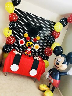 a mickey mouse party with balloons and decorations