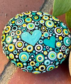 a painted rock with a heart on it