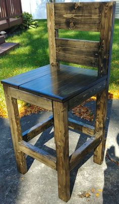 a wooden chair sitting on top of a sidewalk