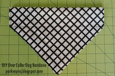 a dog bandana made out of white and black fabric on a green cutting board