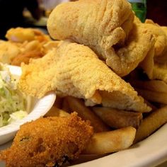 fried fish and french fries with coleslaw on the side