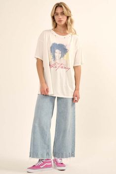 Distressed, garment washed graphic tee. Vintage-style Whitney Houston portrait graphic with signature. Torn and distressed detailing at neckline, cuffs, and hem. Round neckline. Short sleeves. Drop shoulder. Oversized fit. 100% Cotton Imported top designed and printed in LA. Officially licensed Whitney Houston merchandise. Model wears size S. Retro Washed T-shirt, Edgy Soft-washed T-shirt For Spring, Retro Stonewashed Summer Tops, Spring Acid Wash T-shirt With Frayed Hem, Vintage Stonewashed T-shirt For Spring, Stonewashed Graphic Tee For Spring, Spring Stonewashed Graphic Tee, Distressed Graphic Tee, Kiss Logo