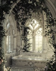 an ornate bathroom with white flowers on the wall and tub in the center, surrounded by greenery